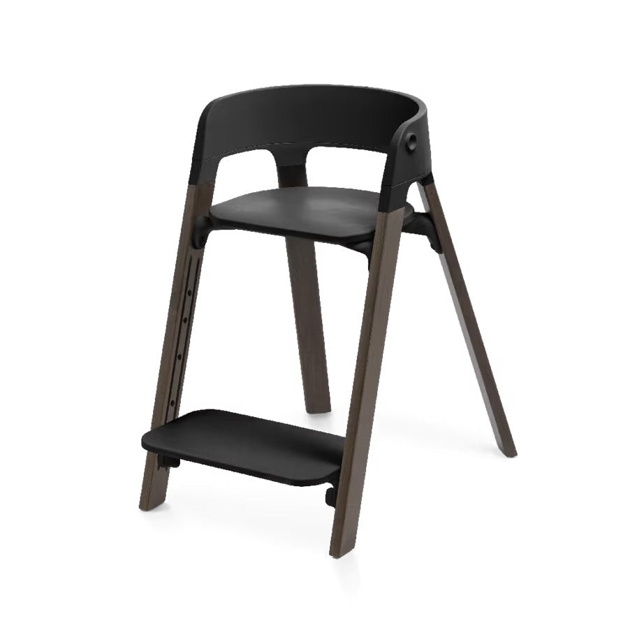 
A modern wooden step stool with a black plastic seat, backrest, and footrest, set against a plain white background.