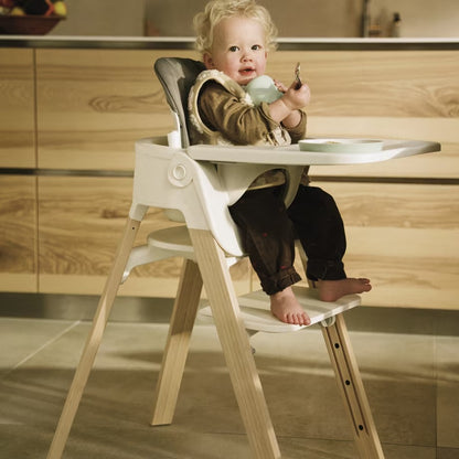 
Child in a high chair in a kitchen setting