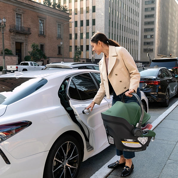 Uppababy Aria in Gwen in with Mom Opening Car Door with Car Seat in Other Hand Lifestyle