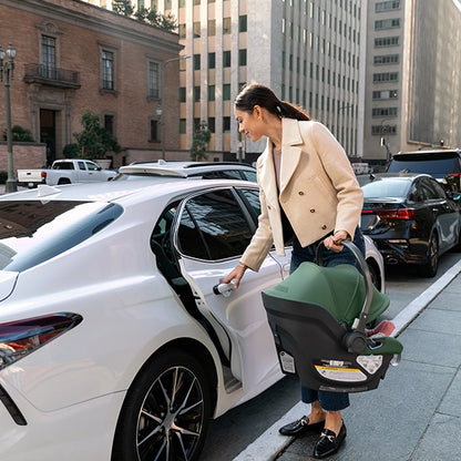 Uppababy Aria in Gwen in with Mom Opening Car Door with Car Seat in Other Hand Lifestyle