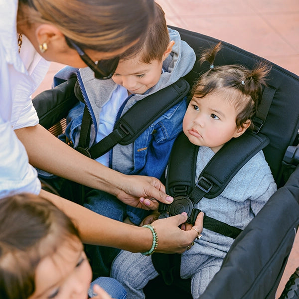 Wonderfold L4 Quad Stroller Wagon in Black Lifestyle of 5-point Safety Harness