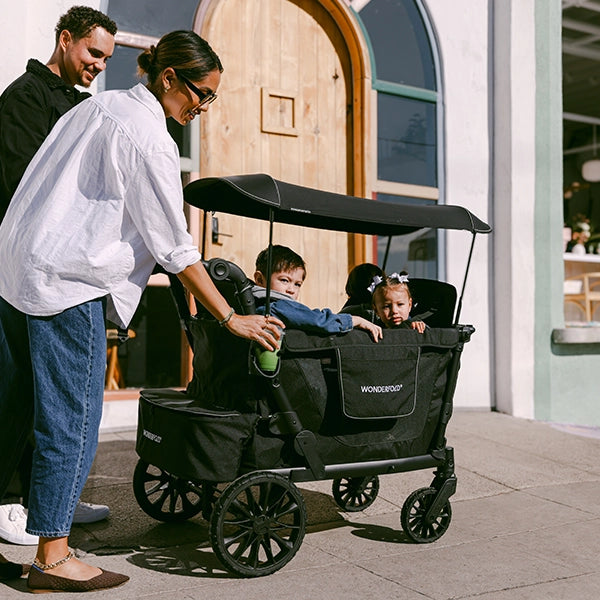 Wonderfold L4 Quad Stroller Wagon in Black Lifestyle View Free Cup Holder Included