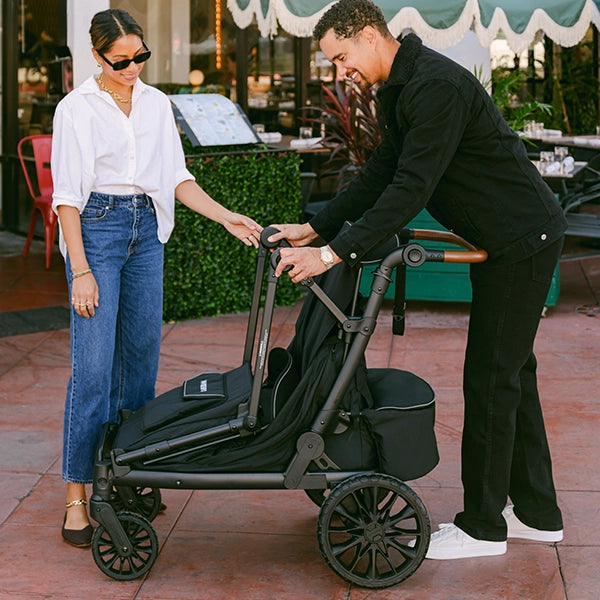 Wonderfold L4 Quad Stroller Wagon in Black Lifestyle Folding in Process