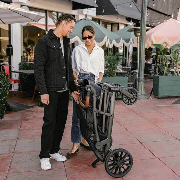 Wonderfold L4 Quad Stroller Wagon in Black Lifestyle Folded and Standing with Kickstand