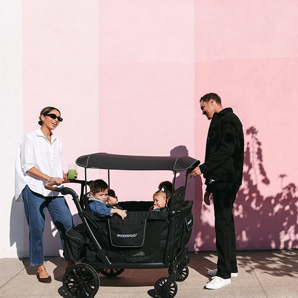 Wonderfold L4 Quad Stroller Wagon in Black Lifestyle View