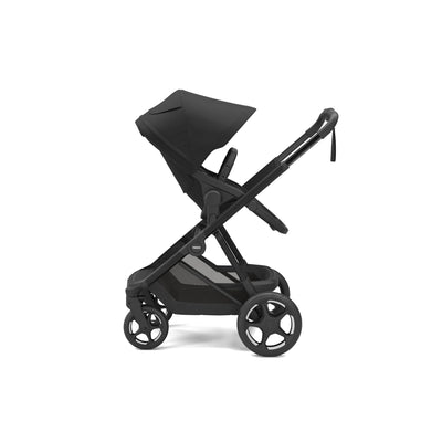 A side view of the Thule Charm stroller with a toddler seat in black, reclined and facing the parent.
