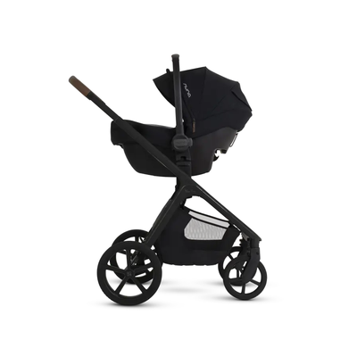 Side profile of the Silver Cross Cove 2 stroller functioning as a travel system with a compatible Nuna infant car seat attached.

