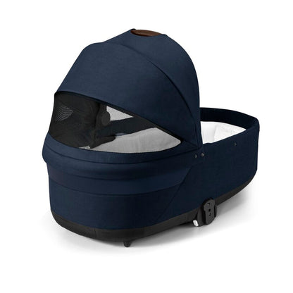 
Brown baby bassinet with mesh window on a white background
