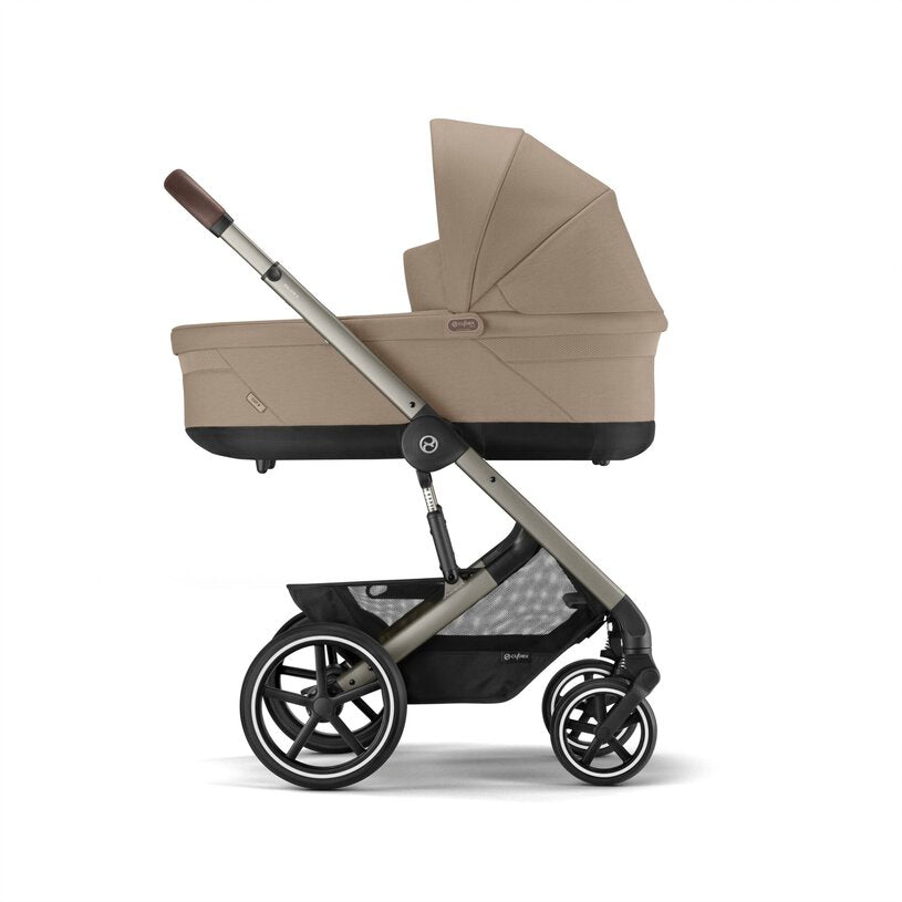 
Beige and black stroller on a white background