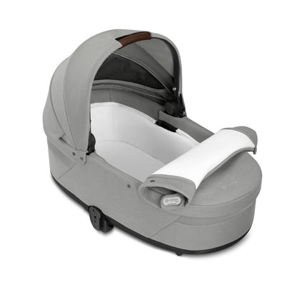 
Gray baby car seat with white cushion on a white background