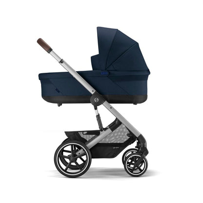 
Navy blue stroller with a black seat on a white background