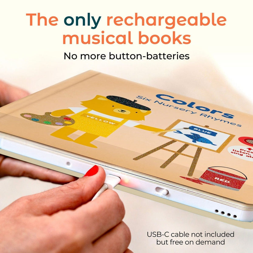 
A person's hands are shown plugging a USB-C cable into a white electronic device, which is a rechargeable children's book titled 'Colors: Six Nursery Rhymes' with colorful illustrations of a yellow bear and a blue bird. Text overlays describe the product's features.