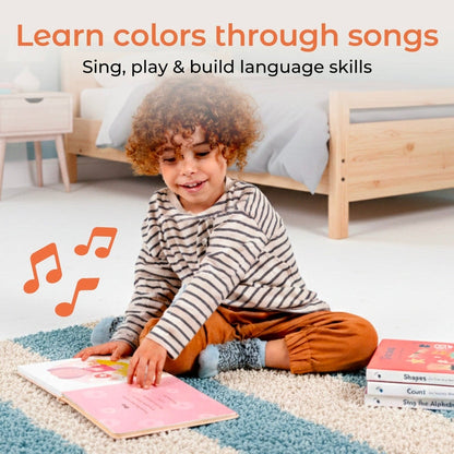 
Child sitting on a rug with educational books, surrounded by musical notes, in a bedroom setting.