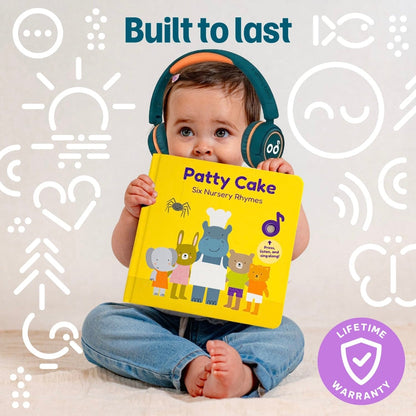 
A baby wearing headphones sitting cross-legged while holding a yellow interactive sound book titled *"Patty Cake - Six Nursery Rhymes"*.