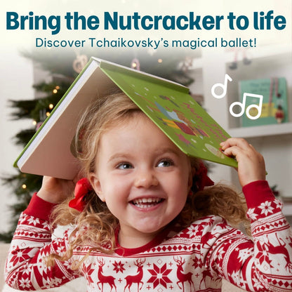 
A smiling child in holiday pajamas holding an open "The Nutcracker" book over her head like a roof.